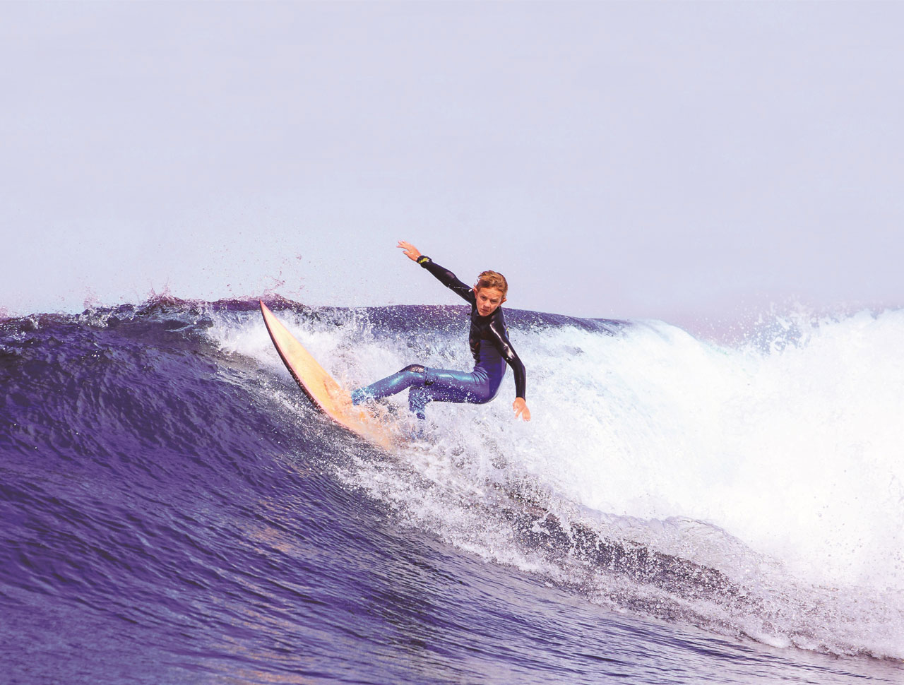 Woman surfing ocean wave